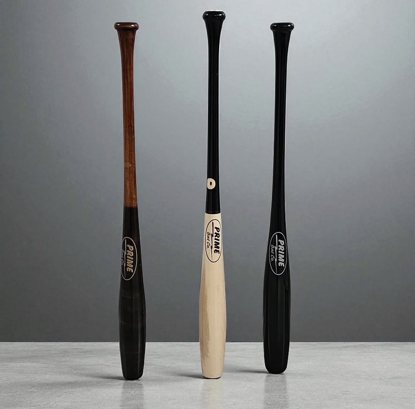 Three Prime Bat Co bats in a clean studio-style product photo
